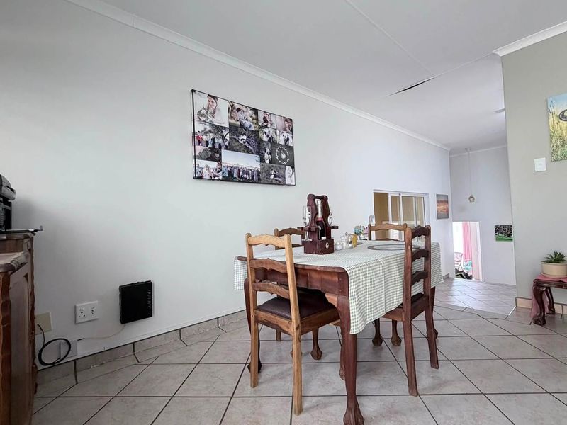 Dining area featuring ceramic tiled flooring and coved ceilings, showing signs of ceiling damage requiring repair.