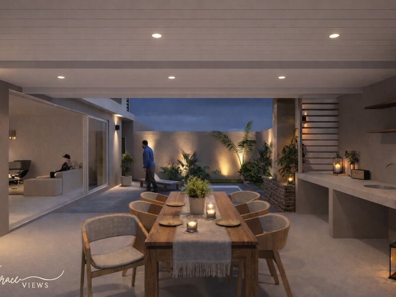 A modern covered patio featuring recessed lighting, a built-in concrete prep area, and seamless transition to the interior living space.