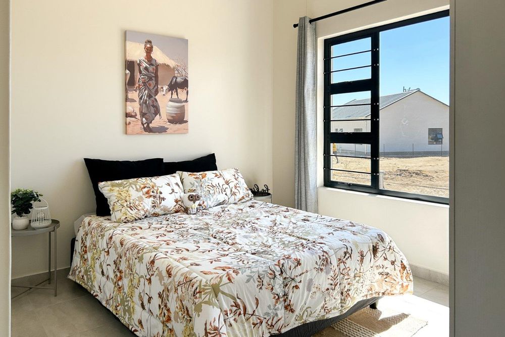 Spacious second bedroom with built-in cupboards.