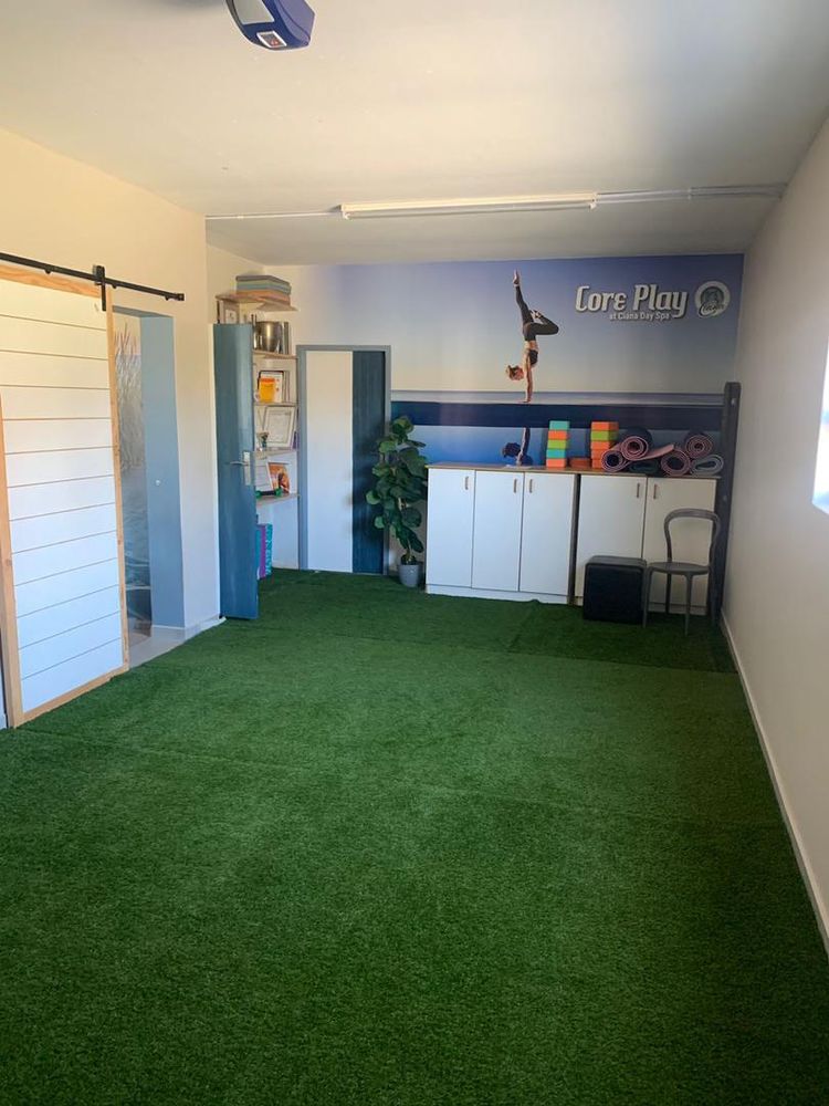 Tandem garage with fake grass next to the flat downstairs