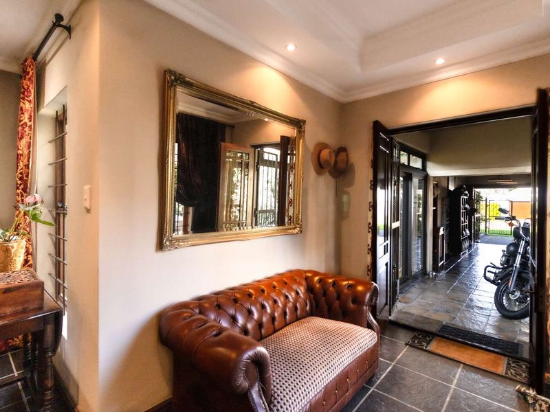 Welcoming entrance hall featuring tiled flooring, recessed ceiling lighting, and a double door entry leading to the main living area.