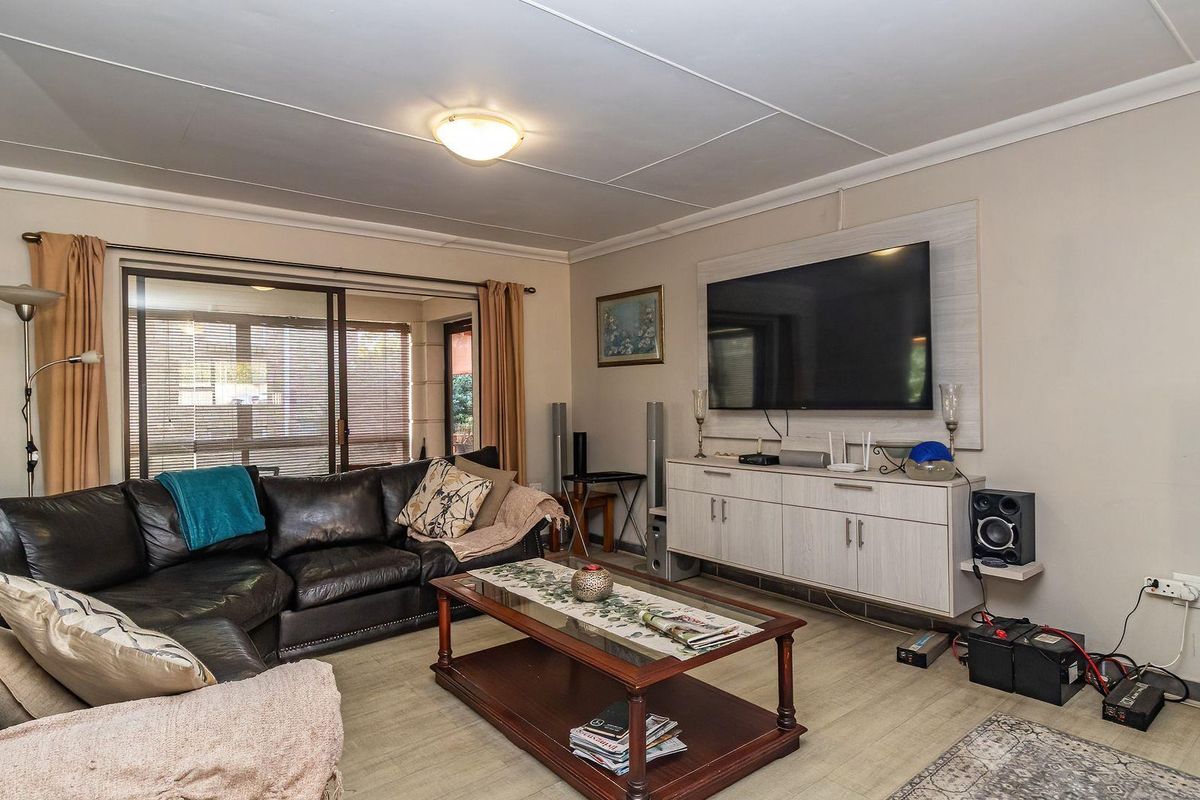 A comfortable living room featuring a sliding glass door providing natural light and access to the outdoor area.
