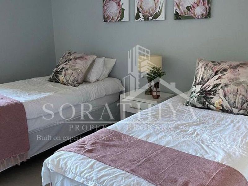A bedroom featuring neutral wall tones and tiled flooring, suitable for a guest room or children's bedroom.