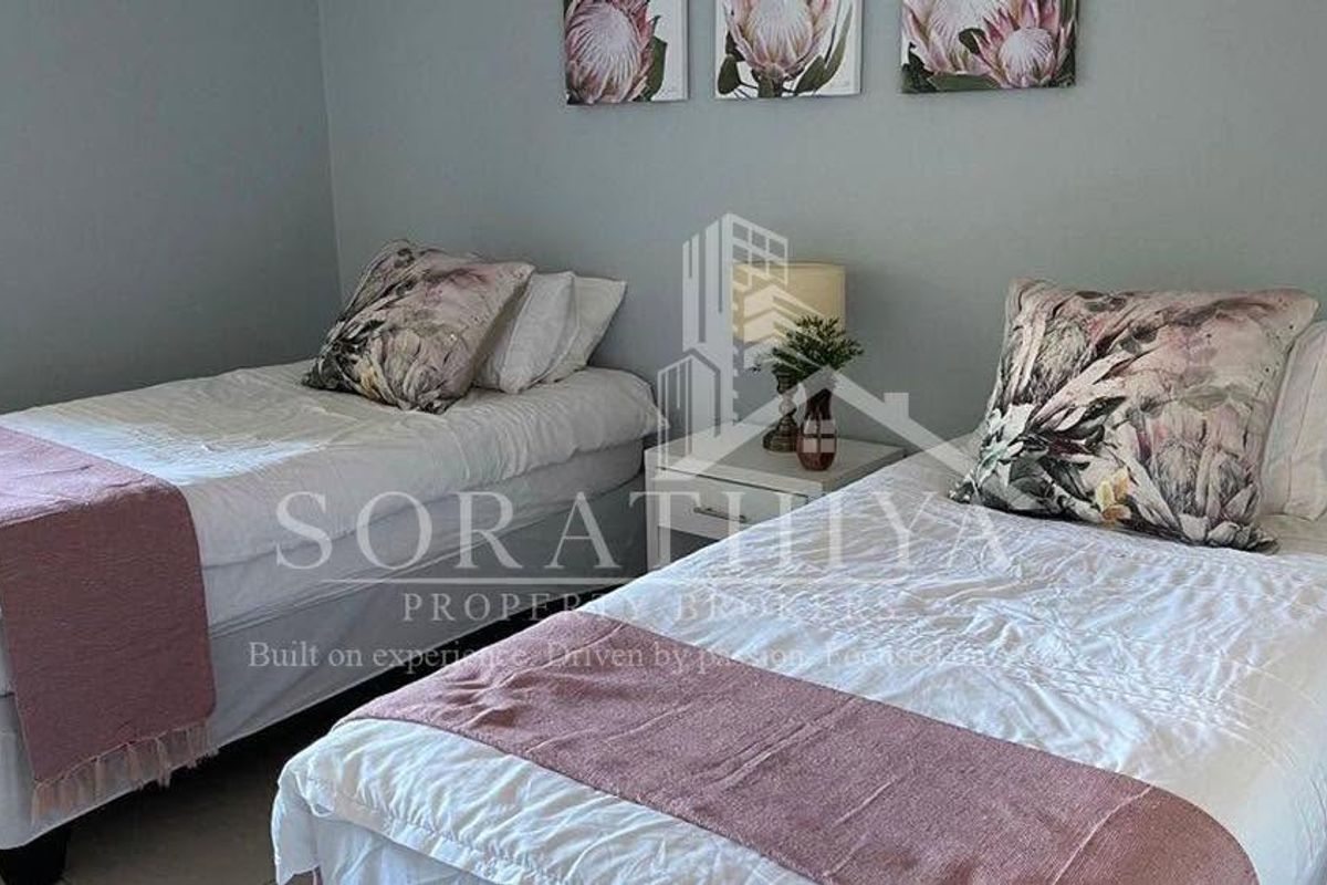 A bedroom featuring neutral wall tones and tiled flooring, suitable for a guest room or children's bedroom.
