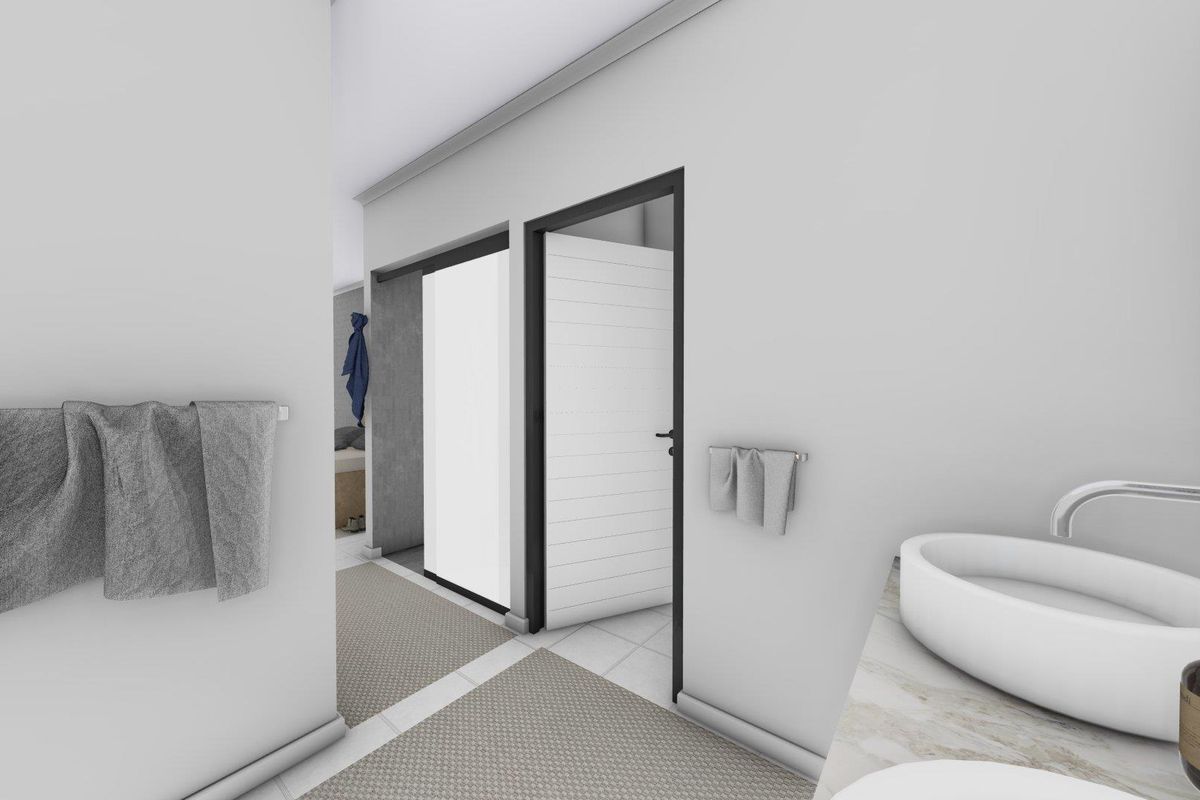 A modern bathroom featuring a sleek countertop basin, contemporary fixtures, and clean lines, leading into an adjacent bedroom area.