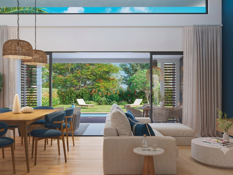 Spacious open-plan living and dining area featuring high ceilings, clerestory windows, and large sliding doors opening to a landscaped garden and pool area.
