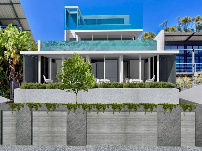 Modern multi-level apartment building featuring a glass-fronted balcony, contemporary facade design, and integrated lower-level garage access.