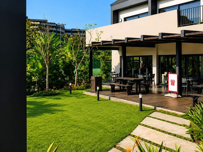 A well-maintained outdoor patio area featuring timber decking, a pergola structure, and direct access to a landscaped garden with paved pathways.