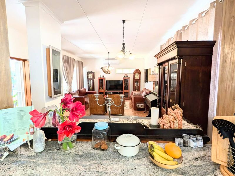 Open plan living area featuring a kitchen breakfast bar overlooking the spacious lounge, creating a functional and connected living space.