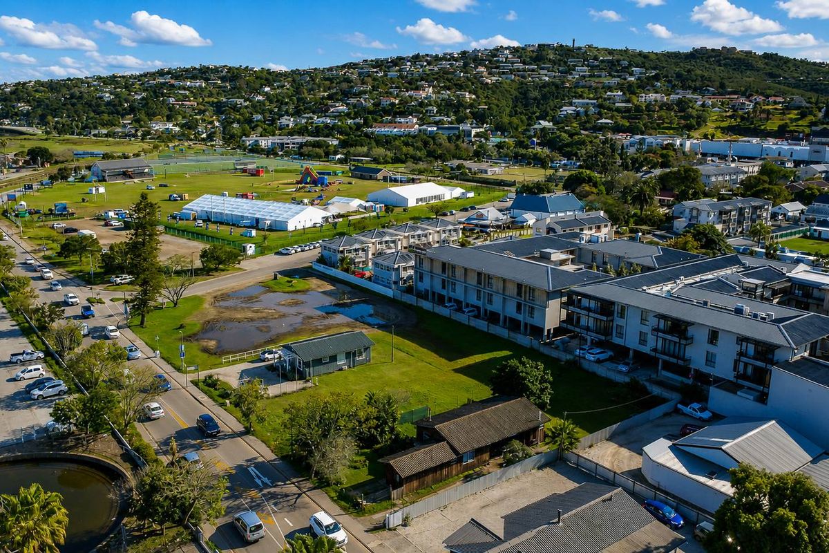 Aerial view of a vacant residential plot situated within an established urban neighborhood, offering proximity to local amenities and surrounding residential infrastructure.