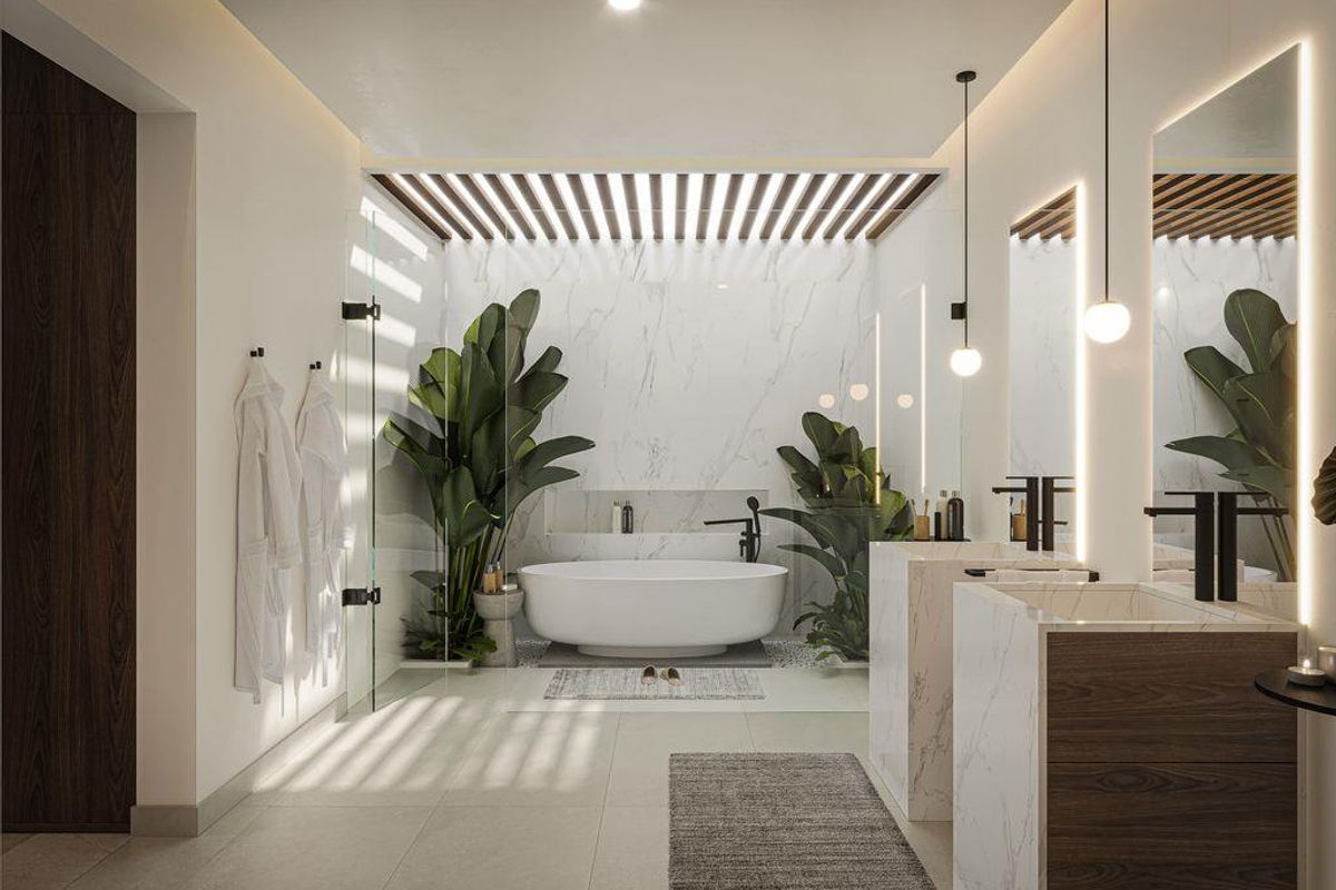 Luxurious modern bathroom featuring a freestanding bathtub, dual marble-clad vanity units, integrated LED mirror lighting, and a decorative timber-slat ceiling detail.