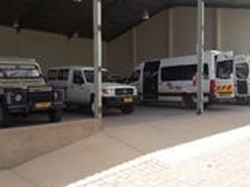 A large industrial covered parking or loading bay featuring a steel portal frame structure and concrete hardstand area.