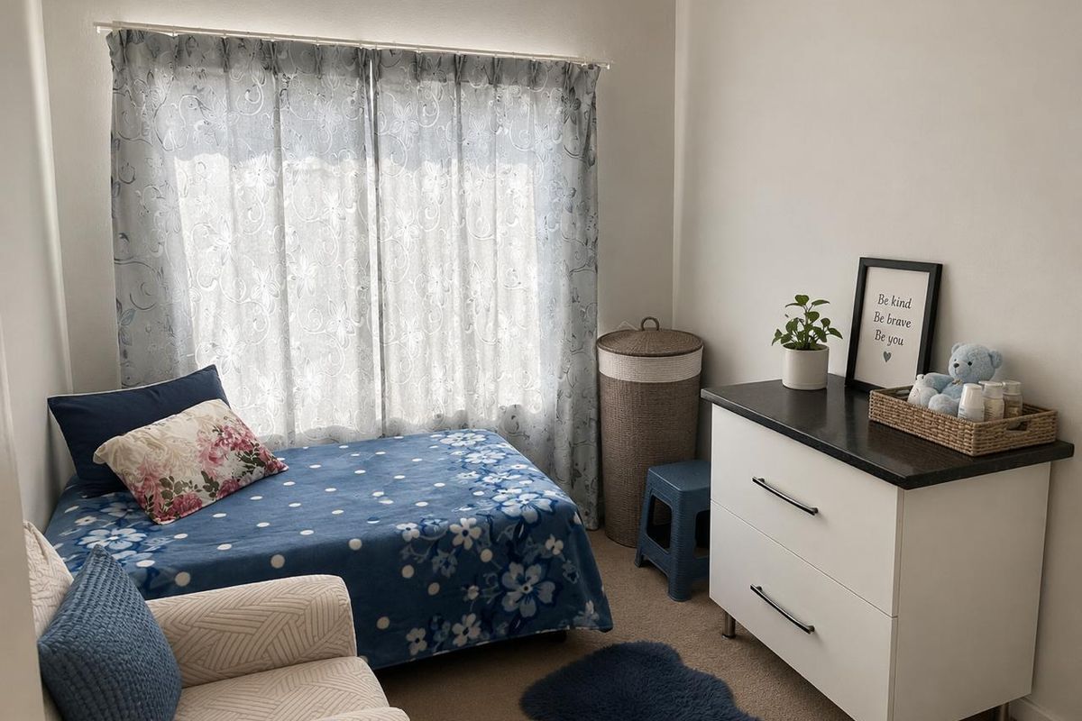 A cozy bedroom featuring neutral wall finishes and carpeted flooring, providing a comfortable and functional living space.