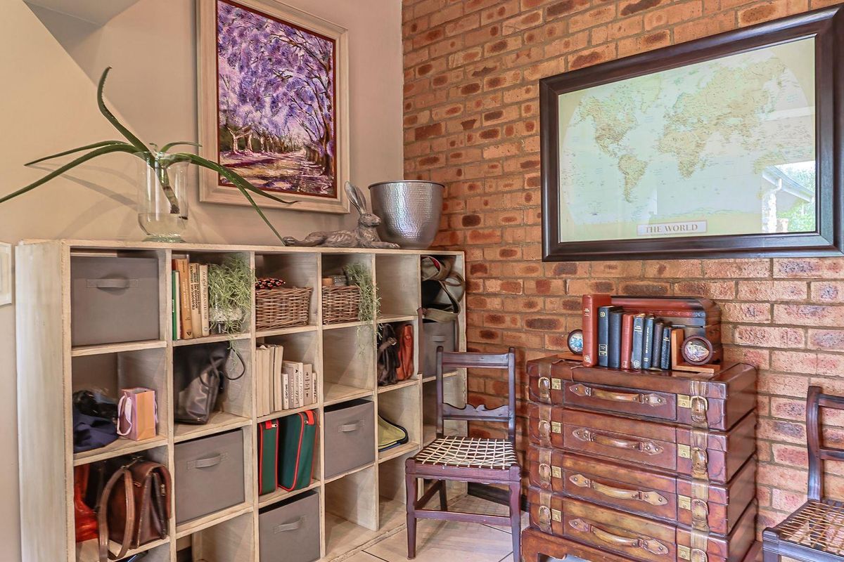 A cozy interior space featuring a rustic exposed brick feature wall and tiled flooring, providing a warm and textured aesthetic.
