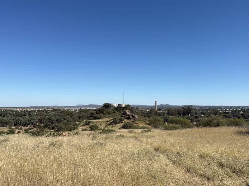 A wide-angle view of the natural landscape and surrounding terrain, showcasing the open space and distant horizon.