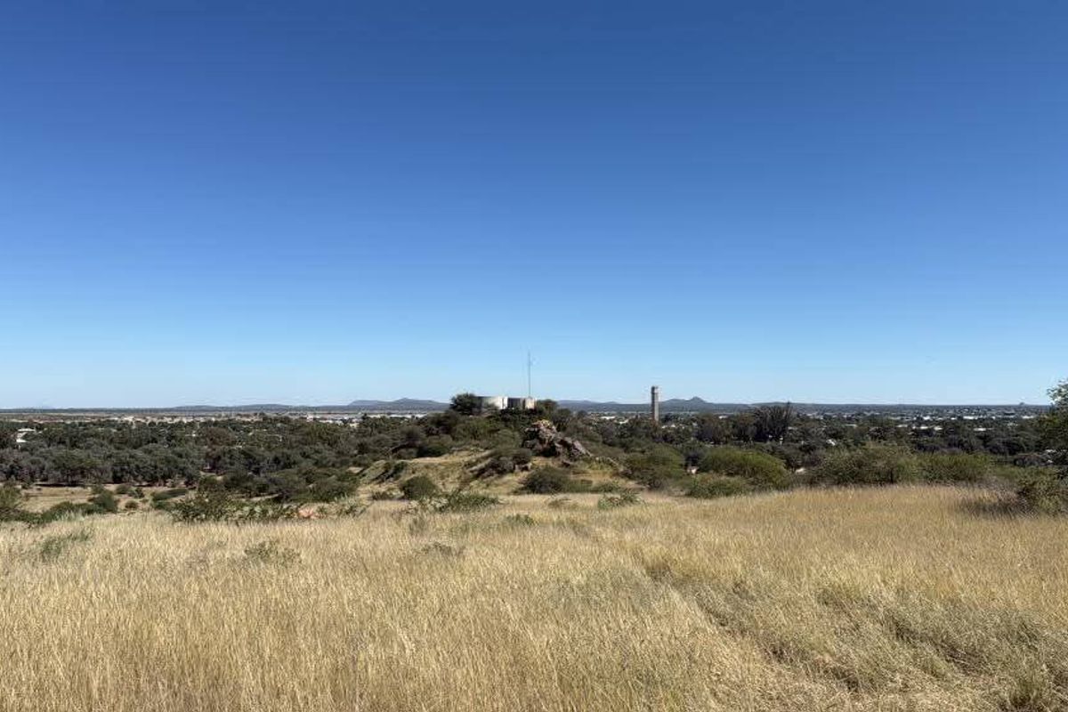 A wide-angle view of the natural landscape and surrounding terrain, showcasing the open space and distant horizon.