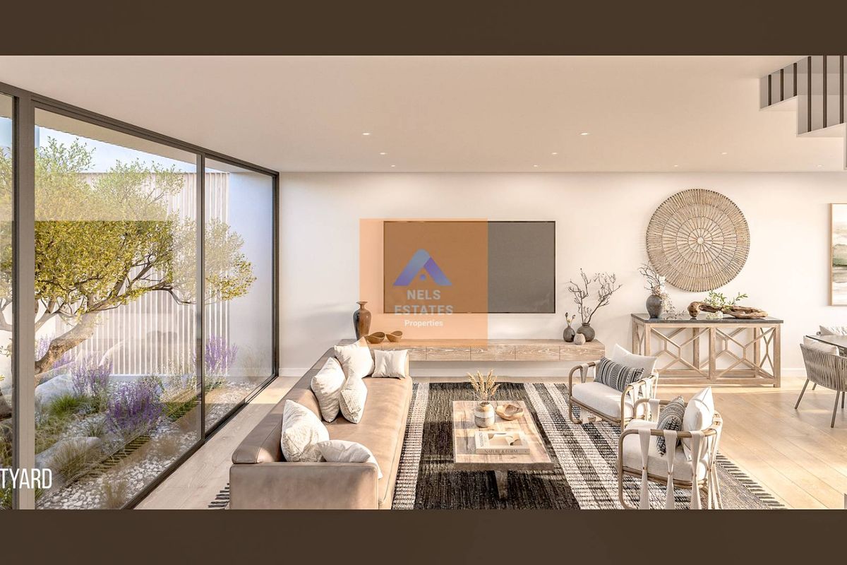 Modern open-plan living area featuring floor-to-ceiling glass walls overlooking a private courtyard, recessed lighting, and sleek floating cabinetry.