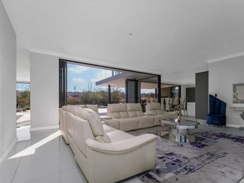Spacious open-plan living area featuring large bi-fold doors that provide seamless indoor-outdoor flow and abundant natural light.