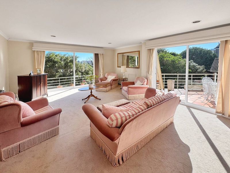 Spacious living room featuring large sliding glass doors that provide abundant natural light and direct access to an outdoor balcony area.