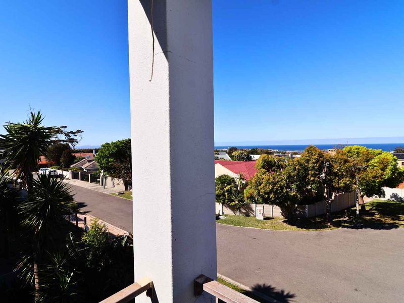 Elevated view overlooking the surrounding residential neighbourhood with a clear horizon line and distant ocean view.