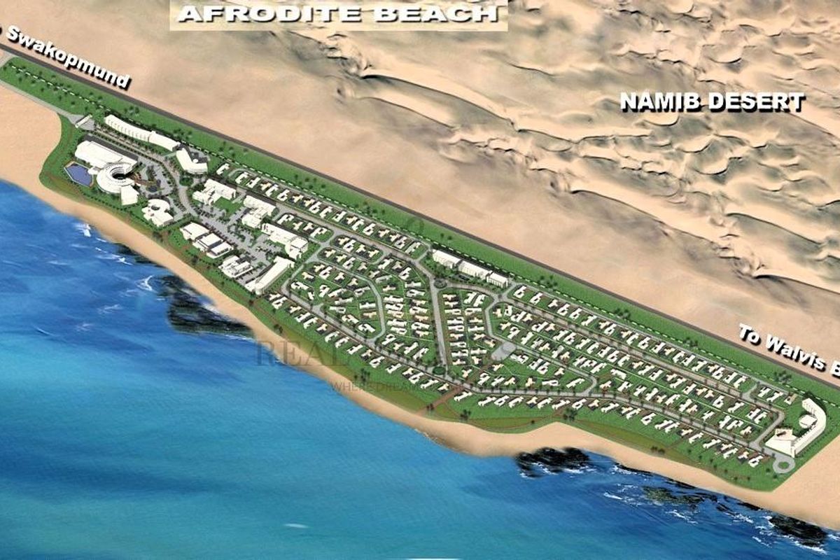 An aerial view of the Afrodite Beach residential development, showcasing the layout of the land plots situated between the ocean and the Namib Desert.