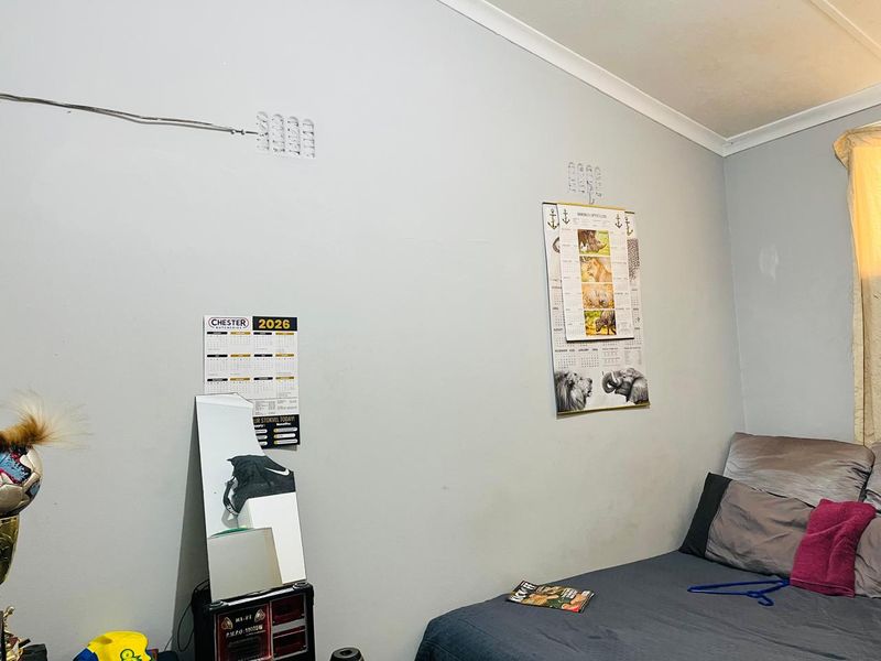 A bedroom featuring plain walls with coving and skirting boards, requiring minor cosmetic repairs and updates to improve the overall finish.