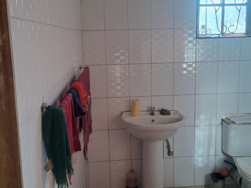 Peaceful 3-Bedroom Family Home with 2 Rondavels for Extra Income Potential - Photo 9