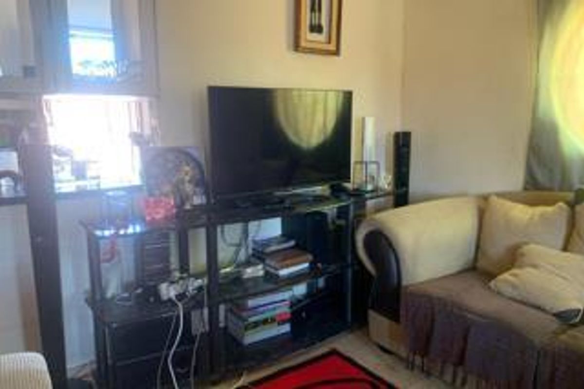 A view of a living room area featuring a built-in pass-through window to the kitchen.