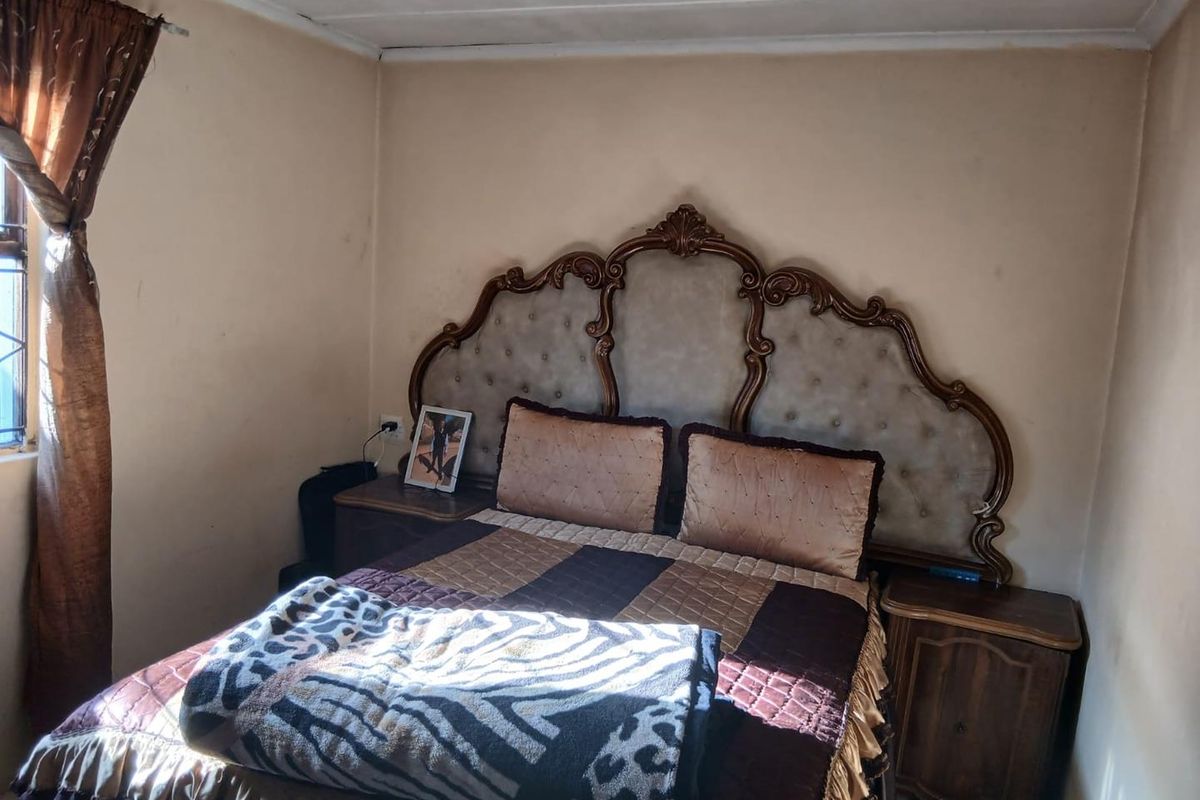 A bedroom featuring neutral wall finishes and an electrical outlet, requiring cosmetic updates to improve the overall aesthetic and condition of the space.