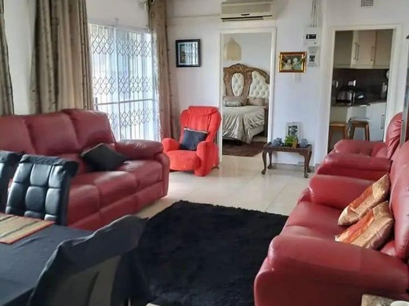 Open plan living and dining area featuring tiled flooring, air conditioning, and direct access to adjacent bedroom and kitchen spaces.