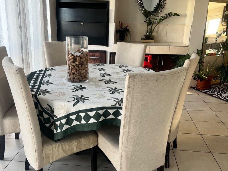 A dining area featuring tiled flooring and a built-in fireplace, providing a functional space for meals and gatherings.