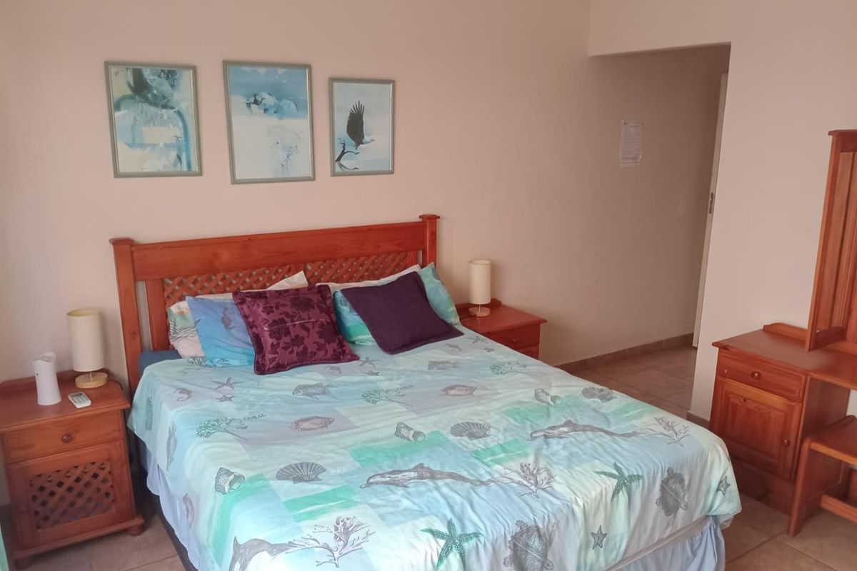 A standard bedroom featuring tiled flooring and a neutral wall finish, providing a functional and comfortable sleeping space.