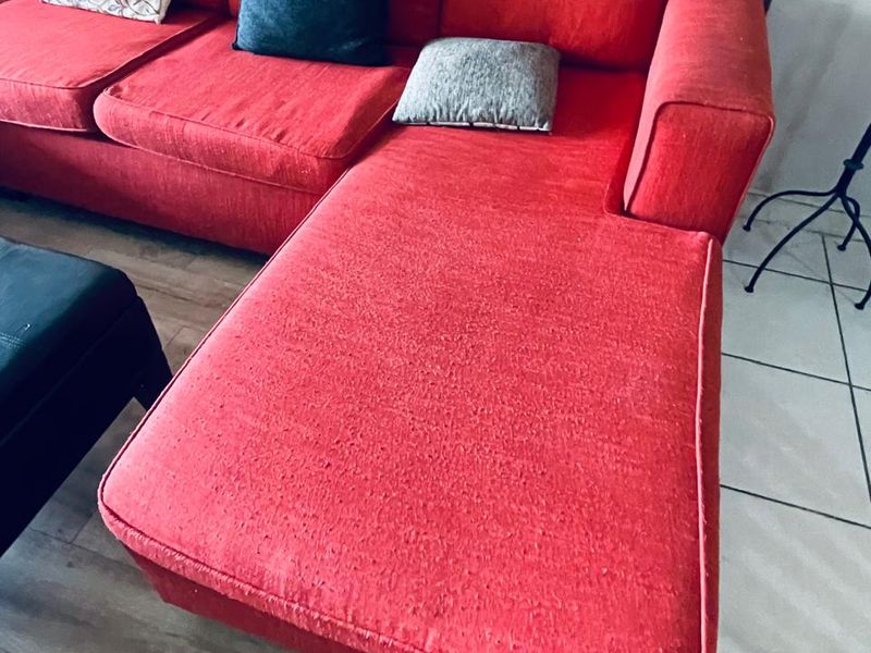 A living room area featuring a combination of tiled and laminate flooring.