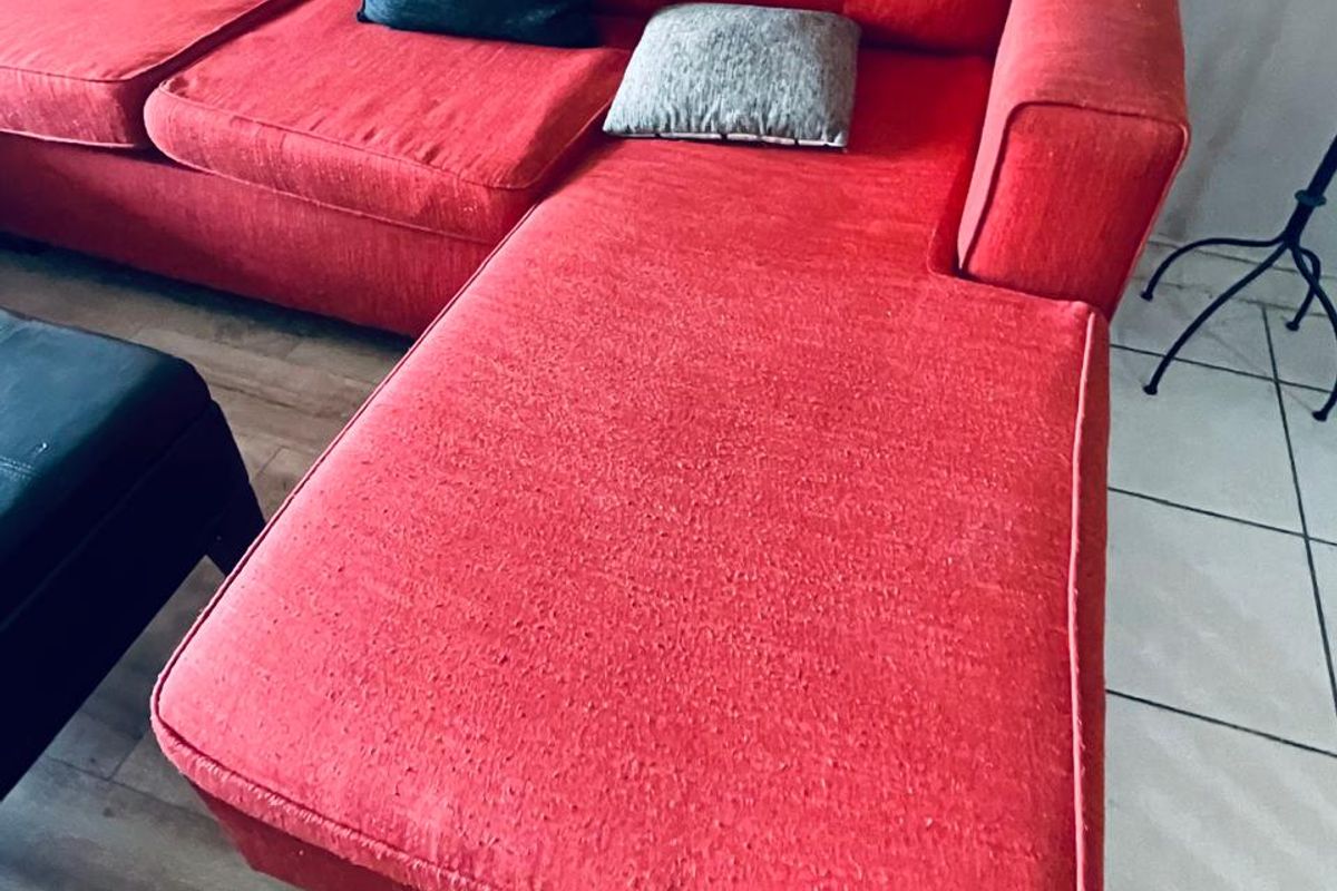 A living room area featuring a combination of tiled and laminate flooring.