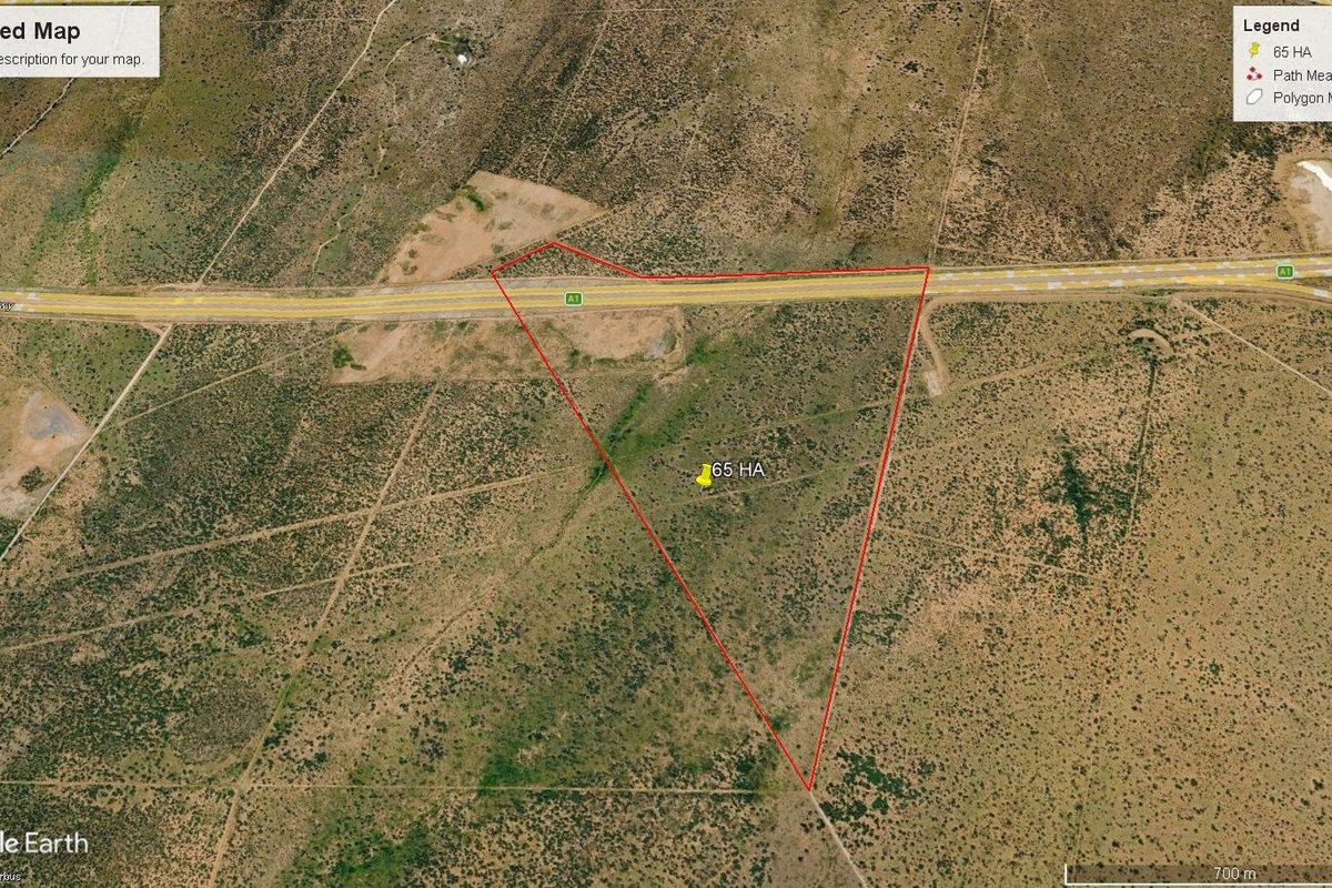 Aerial view of a 65-hectare agricultural land parcel with direct highway frontage.