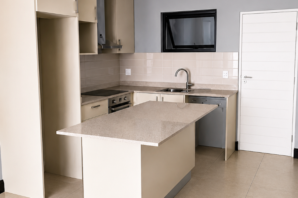 Modern kitchen featuring neutral cabinetry, stone countertops, a central island, integrated appliances, and tiled flooring in a clean, open-plan layout.