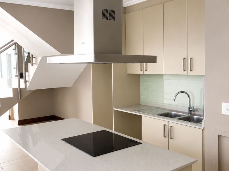 Modern kitchen featuring a central island with induction cooktop, stainless steel extractor fan, stone countertops, and neutral cabinetry with a subway tile backsplash.