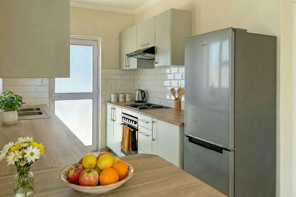 Kitchen with built-in stove and cupboards.
