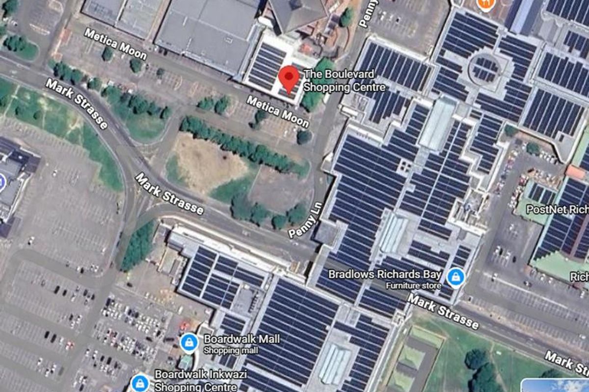Aerial view of The Boulevard Shopping Centre, showcasing the building layout, surrounding parking areas, and street access.