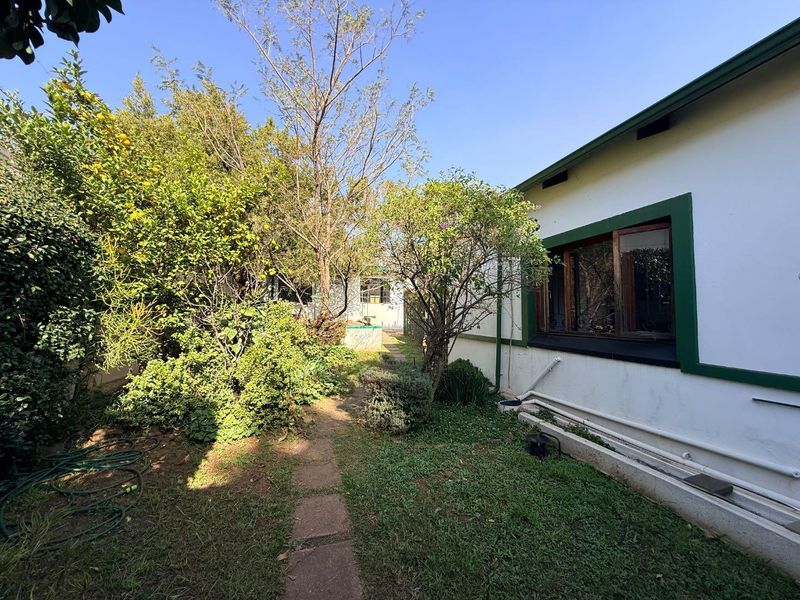 Charming 2-Bed Home with Two Bonus Units for Extra Income - Photo 3