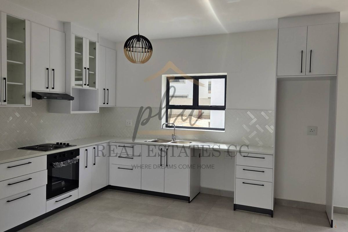 Modern kitchen featuring white cabinetry, stone countertops, built-in oven, gas hob, and a tiled backsplash in a clean, contemporary layout.