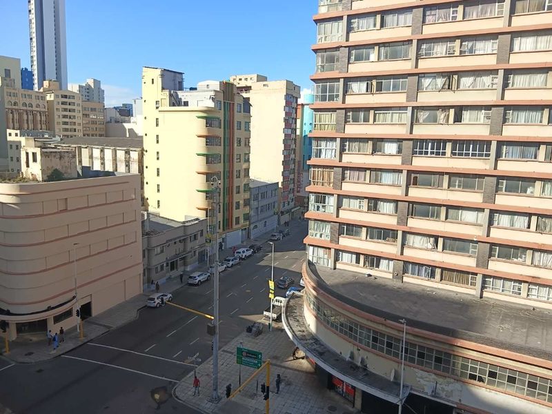 An elevated street view showing surrounding urban apartment buildings and city infrastructure in a dense residential area.