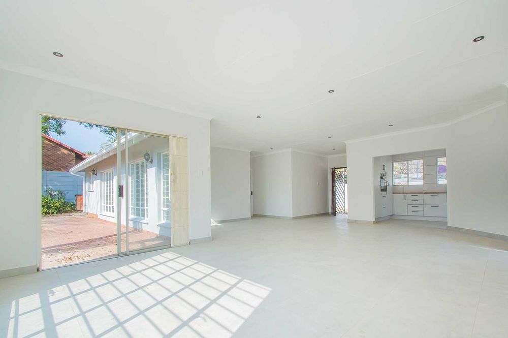 Expansive reception areas with kitchen in backview