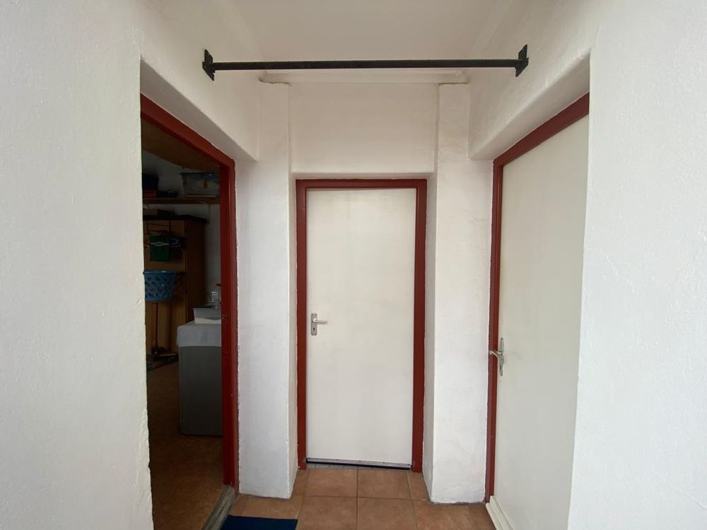 Three doors leading to the laundry room, staff WC and workshop room