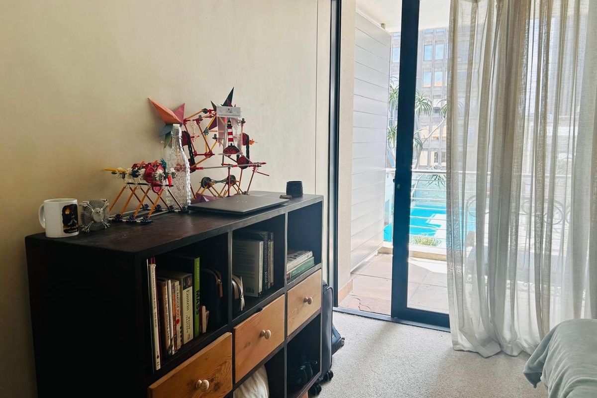 Bedroom featuring carpet flooring and a sliding glass door providing access to a balcony area.