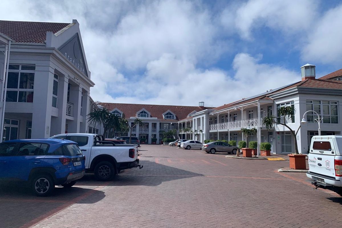 A view of the office complex courtyard featuring paved parking areas and multi-story building facades with classic architectural detailing.