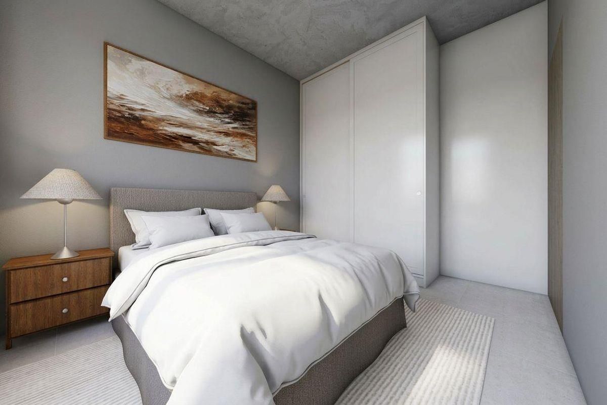 Modern bedroom featuring a sleek built-in wardrobe and a contemporary concrete ceiling finish.