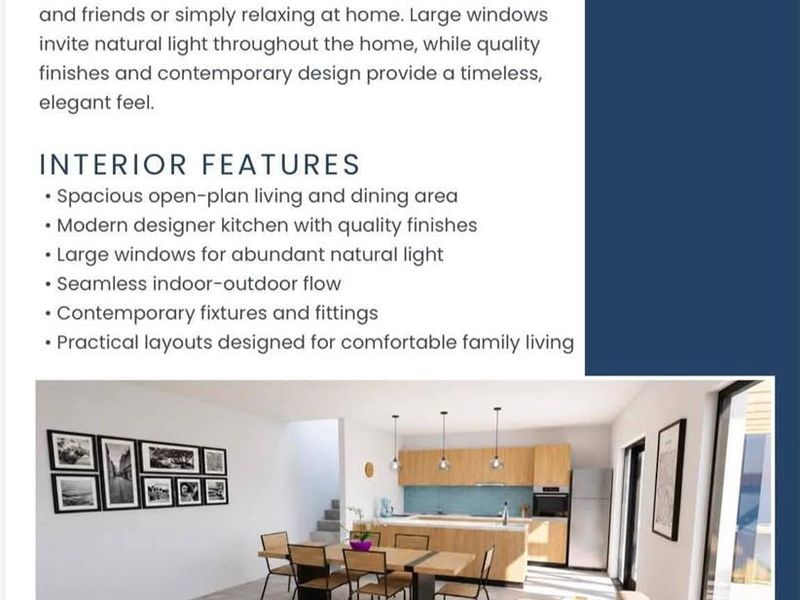 A modern open-plan living, dining, and kitchen area featuring contemporary cabinetry, an island, and large sliding doors providing access to outdoor space.