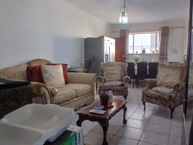 Open plan living and dining area featuring tiled flooring and coved ceilings, offering a functional layout for daily living.