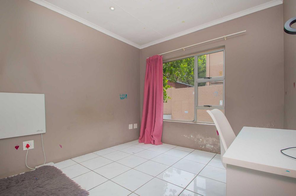 spcious and sunny 3rd bedroom looks out to garden an pool 